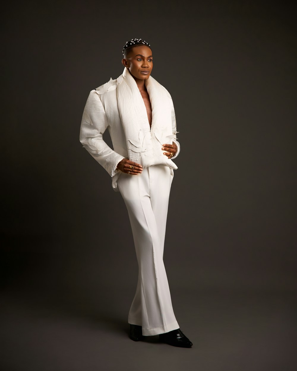 White tailored suit against a dark backdrop